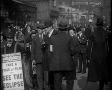 Men Wearing Pathe Gazette Sandwich Boards Handing Out Pieces of Polaroid Film to Crowds..., 1921. Creator: British Pathe Ltd