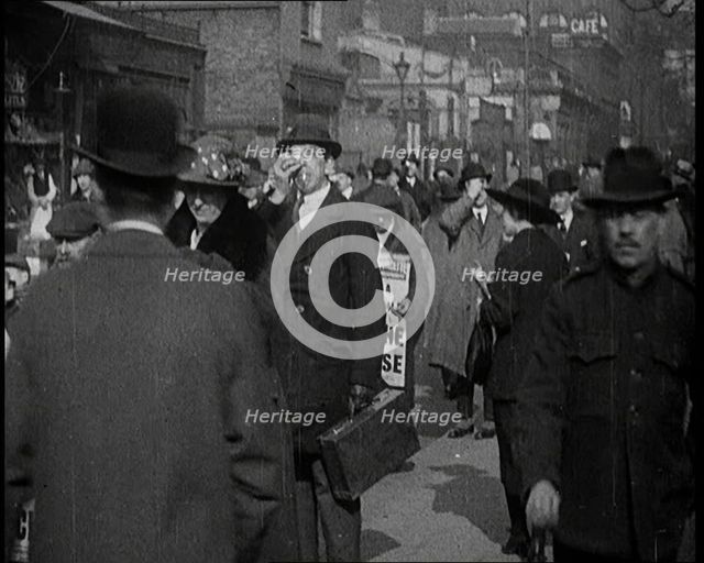 Men Wearing 'Pathe Gazette' Sandwich Boards Handing Out Pieces of Polaroid Film to Crowds..., 1921. Creator: British Pathe Ltd.