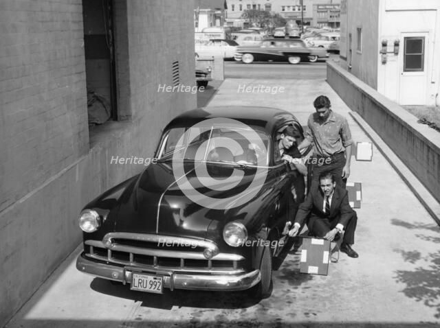 Men with a 1949 customised Chevrolet, (c1949?). Artist: Unknown