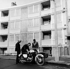 Men with a motorbike, Queen's Crescent, St Pancras, London, 1965. Creator: Henry Grant