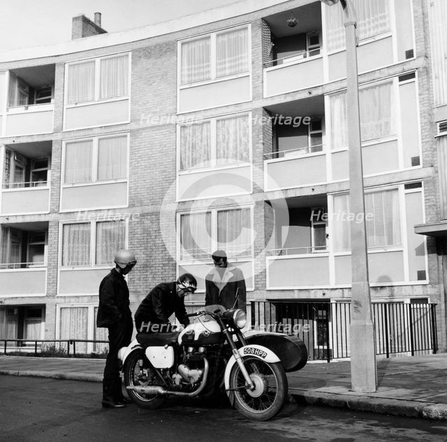 Men with a motorbike, Queen's Crescent, St Pancras, London, 1965.  Creator: Henry Grant.