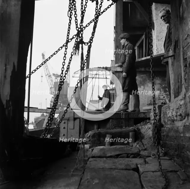 Men working at a wharf on the River Thames in Limehouse, London, c1945-c1965. Artist: SW Rawlings