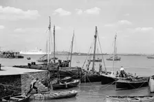 Men working on Bawley boats moored at a quay at Gravesend, c1945-c1965. Artist: SW Rawlings