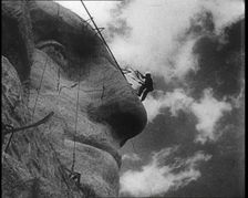 Men Working on Sculpting American President George Washington's Face at Mount Rushmore, 1933. Creator: British Pathe Ltd