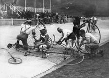 Men working on penny-farthings at a velodrome, c1900-1939(?)