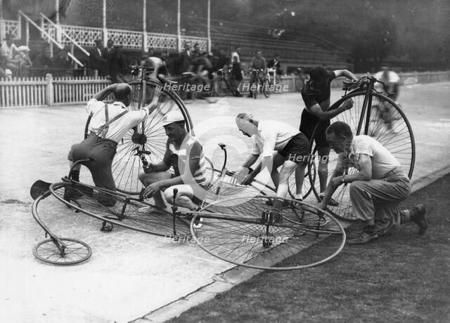 Men working on penny-farthings at a velodrome, c1900-1939(?). Artist: Unknown