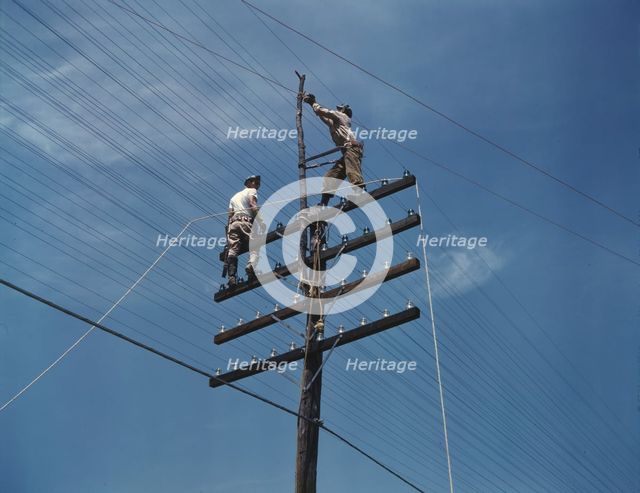 Men working on telephone lines, probably near a TVA dam hydroelectric plant, 1942. Creator: Alfred T Palmer.