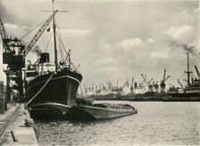 "Merchants Bring In Wares By Ships from Every Nation" Vessels alongside the Quays... 1937. Creator: J Dixon-Scott