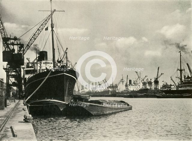 "Merchants Bring In Wares By Ships from Every Nation" Vessels alongside the Quays...', 1937. Creator: J Dixon-Scott.