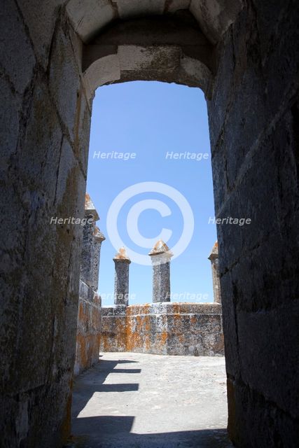 Merlons on the battlements seen through an arched doorway, Beja Castle, Beja, Portugal, 2009.  Creator: Samuel Magal.