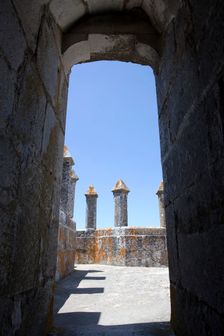 Merlons on the battlements seen through an arched doorway, Beja Castle, Beja, Portugal, 2009. Creator: Samuel Magal