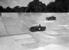 MG C type and Amilcar C6 racing on the banking at Brooklands. Artist: Bill Brunell