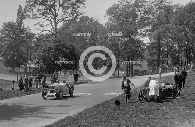MG J2 passing the crashed Austin 7 of B Sparrow, Donington Park Race Meeting, Leicestershire, 1933. Artist: Bill Brunell.