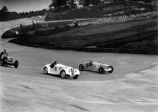 MG K3, Frazer-Nash BMW and Alvis cars racing at Brooklands. Artist: Bill Brunell