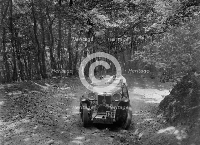 MG Magna competing in the B&HMC Brighton-Beer Trial, Fingle Bridge Hill, Devon, 1934. Artist: Bill Brunell.