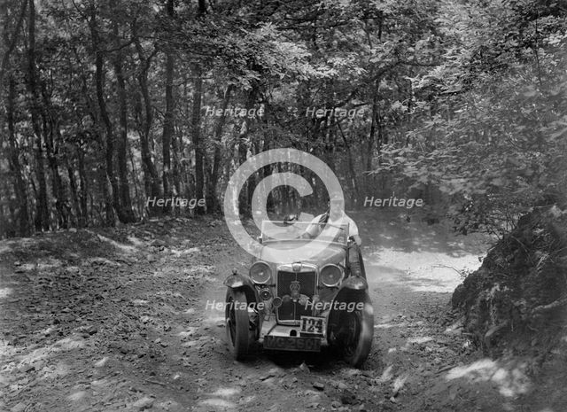 MG Magna competing in the B&HMC Brighton-Beer Trial, Fingle Bridge Hill, Devon, 1934. Artist: Bill Brunell.