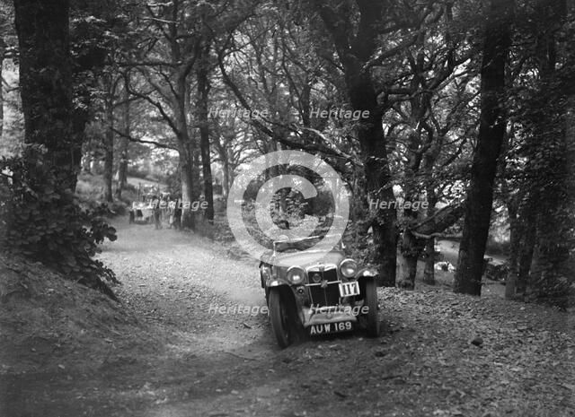 MG Magna competing in the B&HMC Brighton-Beer Trial, Fingle Bridge Hill, Devon, 1934. Artist: Bill Brunell.