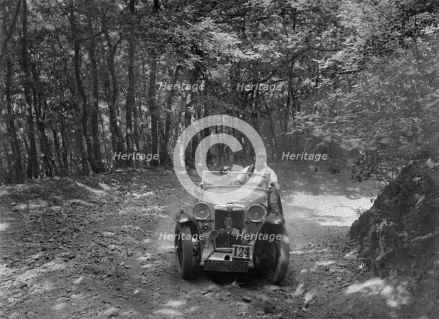 MG Magna competing in the B&HMC Brighton-Beer Trial, Fingle Bridge Hill, Devon, 1934. Artist: Bill Brunell.