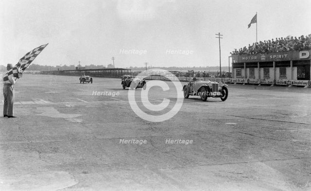 MG Magna of SG Cummings winning a race, BARC meeting, Brooklands, Surrey, 1933. Artist: Bill Brunell.