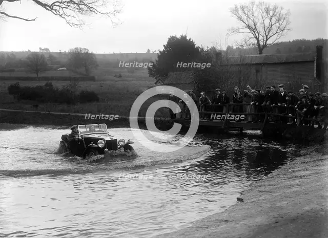 MG Magnette driving through a ford during a motoring trial, 1936. Artist: Bill Brunell.