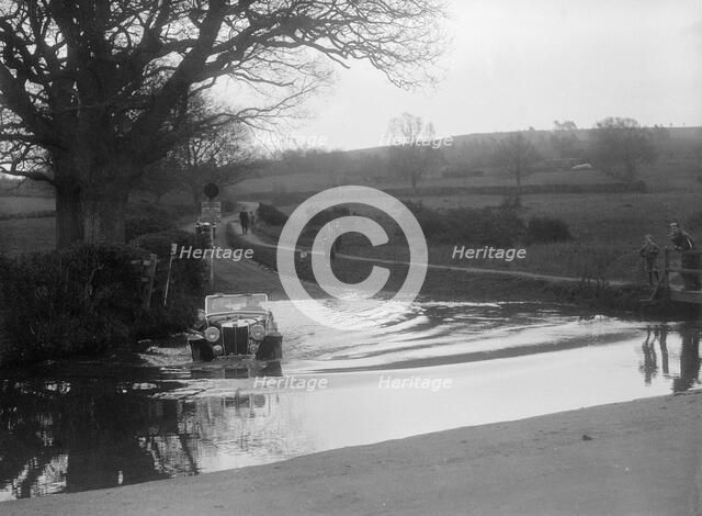 MG Magnette driving through a ford during a motoring trial, 1936. Artist: Bill Brunell.