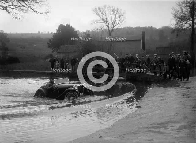 MG PA driving through a ford during a motoring trial, 1936. Artist: Bill Brunell.