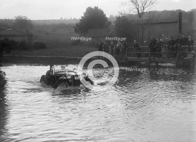 MG PA driving through a ford during a motoring trial, 1936. Artist: Bill Brunell.