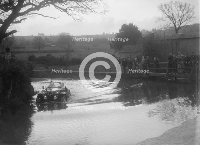 MG PA driving through a ford during a motoring trial, 1936. Artist: Bill Brunell.