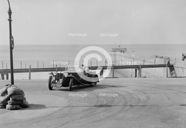 MG TA of FG Cornish competing in the RAC Rally, Madeira Drive, Brighton, 1939. Artist: Bill Brunell.