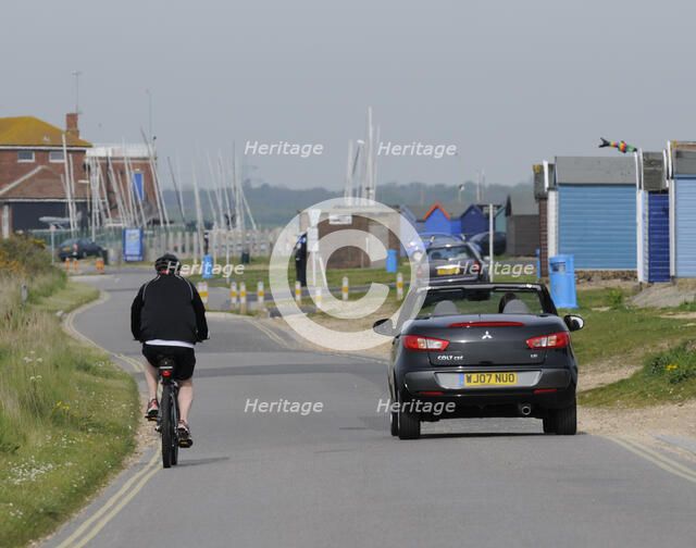 Mitsubishi Colt CZC cabriolet overtaking cyclist