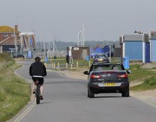 Mitsubishi Colt CZC cabriolet overtaking cyclist