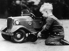 Michael Ware repairing a pedal car