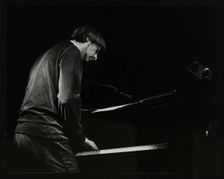 Michael Garrick on the piano at The Stables, Wavendon, Buckinghamshire. Creator: Denis Williams