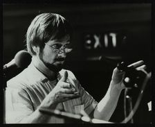 Michael Garrick conducting an orchestra at Berkhamsted Civic Centre, 1985. Artist: Denis Williams