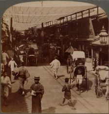 Mid-summer traffic under awnings of Shiro-bashidori, a busy thoroughfare of Kyoto, Japan 1904