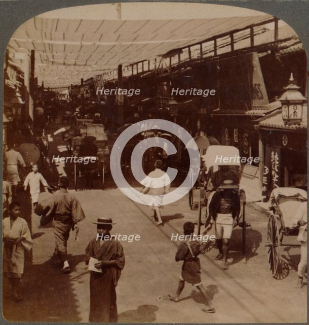 'Mid-summer traffic under awnings of Shiro-bashidori, a busy thoroughfare of Kyoto, Japan', 1904.  Artist: Unknown.