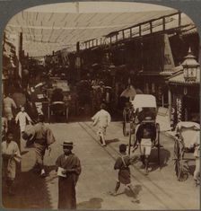 Mid-summer traffic under awnings of Shiro-bashidori, a busy thoroughfare of Kyoto, Japan 1904