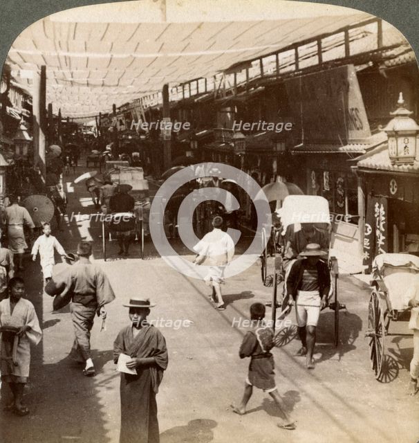 Midsummer traffic under the awnings of Shijo Bashidori, a busy thoroughfare of Kyoto, Japan, 1904. Artist: Underwood & Underwood