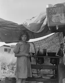 Migratory child in camp at end of day, Bean pickers camp near West Stayton, Oregon , 1939. Creator: Dorothea Lange