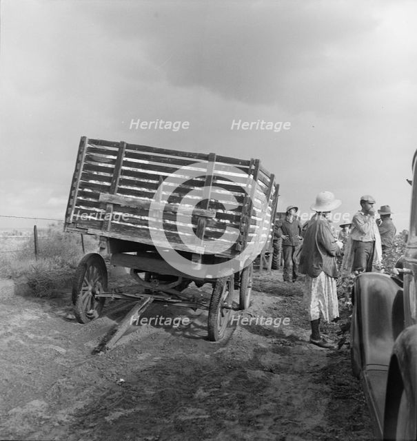Migratory cotton pickers have stopped working because it started to rain, Kern County, CA, 1938. Creator: Dorothea Lange.