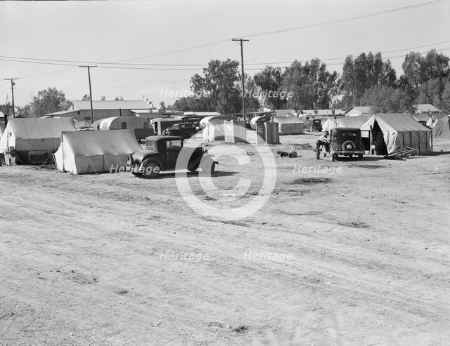 Migratory labor housing during carrot harvest, near Holtville, Imperial Valley, California, 1939. Creator: Dorothea Lange.