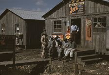 Migratory laborers outside of a "juke joint" during a slack season, Belle Glade, Fla., 1941. Creator: Marion Post Wolcott