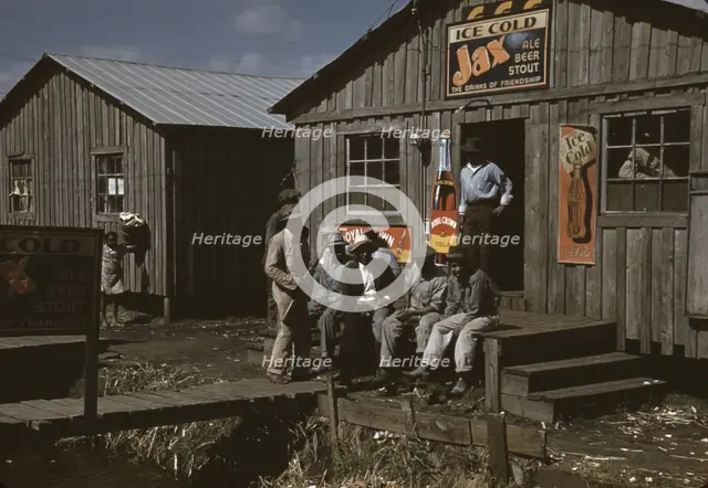 Migratory laborers outside of a "juke joint" during a slack season, Belle Glade, Fla., 1941. Creator: Marion Post Wolcott.