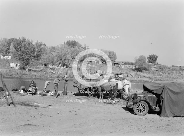 Migrant family cleaning up, near Vale, Malheur County, Oregon, 1939. Creator: Dorothea Lange.