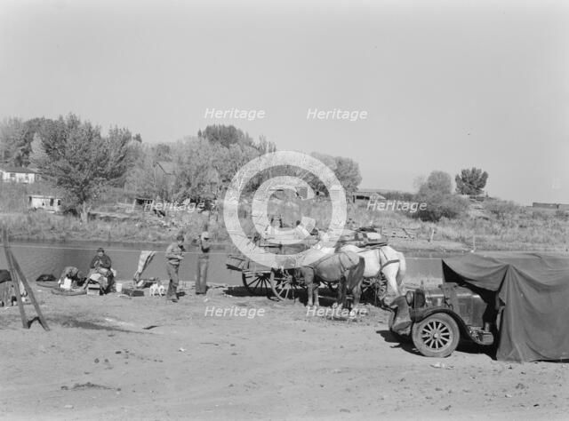 Migrant family cleaning up, near Vale, Malheur County, Oregon, 1939. Creator: Dorothea Lange.