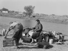 Migrant family cleaning up, near Vale, Malheur County, Oregon, 1939. Creator: Dorothea Lange
