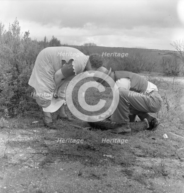 Migrant pea workers on the road with tire trouble, California, 1936. Creator: Dorothea Lange.
