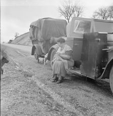 Migrant pea workers on the road, all their worldly possessions in car and trailer, California, 1936. Creator: Dorothea Lange
