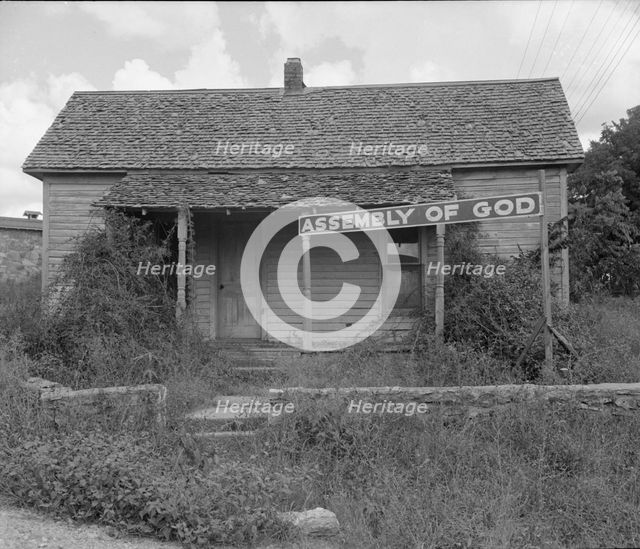 Migrants carry this sect to California, Northern Arkansas on U.S. 62, 1938. Creator: Dorothea Lange.