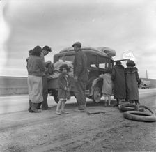 Migrants, family of Mexicans, on road with tire trouble, looking for work...California, 1936. Creator: Dorothea Lange